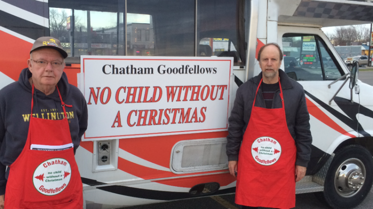 Lee Harris and Peter Kralo of Chatham Goodfellows coordinate street sales volunteers at Nortown Plaza this afternoon.
