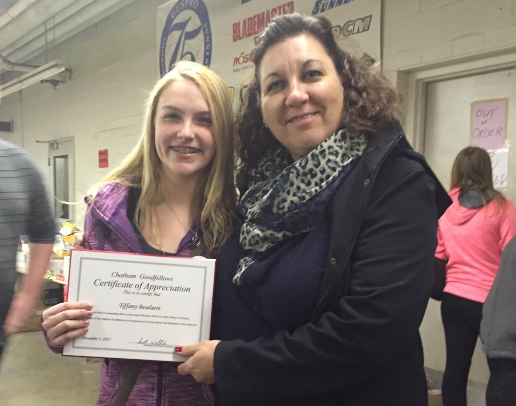Tiffany Beseleare receives her Certificate of Appreciation from Rose Peseski for her dedications to toy packing.