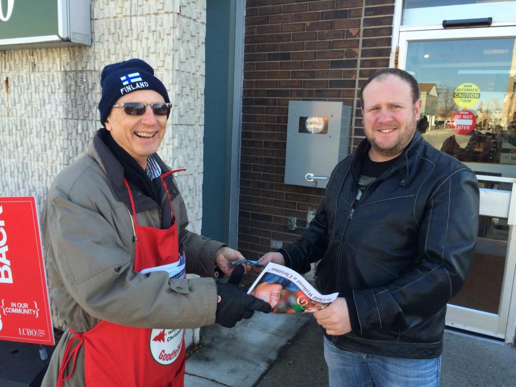 Goodfellow Ted Sojczynski collects a donation from Brad Kerr during Chatham Goodfellows annual street sales campaign on Friday December 11, 2015.